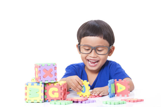 Cute boy playing with letters 