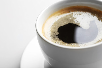 A cup of tasty coffee, isolated on white, close-up