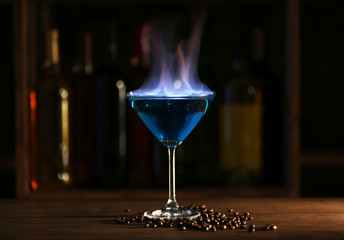 Burning cocktail on table in a bar