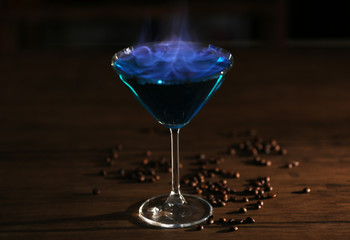 Burning cocktail and coffee beans on a table