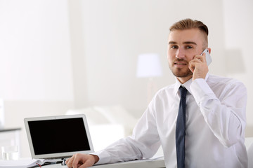 Businessman working with laptop in office