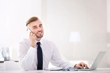 Businessman working with laptop in office