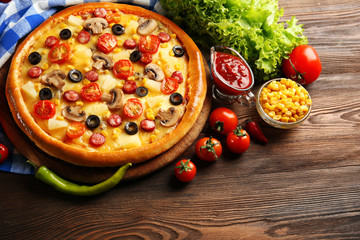 Delicious pizza with vegetables and meat, close-up