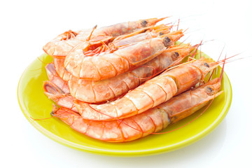 plate of raw prawns on white background
