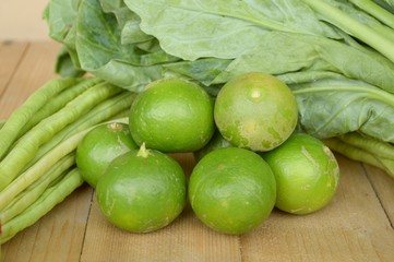 green lime yardlong bean and kale on wood floor