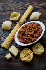 Bolognese sauce with various types of raw italian pasta