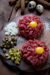 Close-up of two beef tartares with egg yolk, selective focus