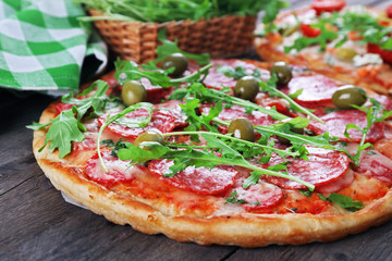 Delicious tasty pizza with ingredients on table, closeup
