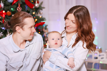 Happy family on the floor in the decorated Christmas room