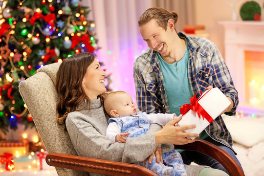 Christmas concept: happy family in decorated room