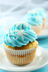 Blue cakes on plate on wooden background