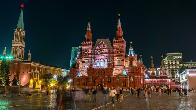 Illuminated State Historical Museum at Red Square at night in Moscow, Russia. Blurred people, hyperlapse, black sky at the background