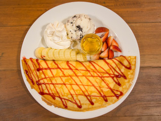 ice creame crape with strawberry sauce and banana