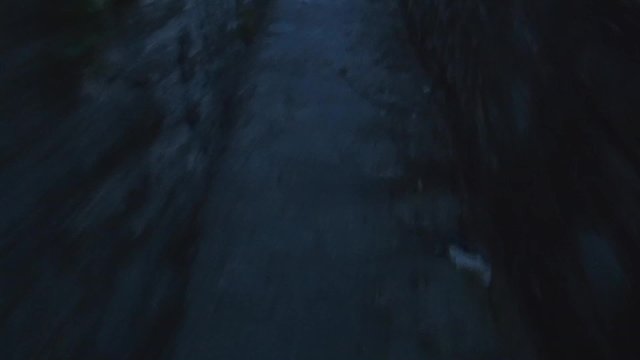 walking by narrow corridor of old city with focus on pavement