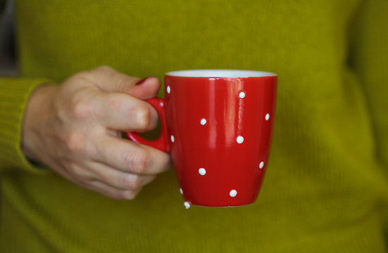 Woman Hands Holding A Cozy Red Mug