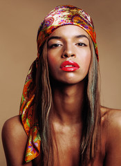 beauty young afro american woman in shawl on head smiling close up, warm colors swag