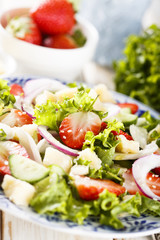 Strawberry salad with cucumber, red onion and parmesan cheese