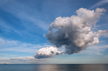 Naklejka na ściany i meble Large dark cloud over sea with the ship.