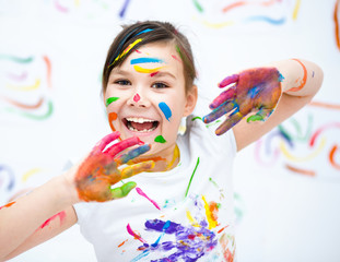 Cute girl playing with paints