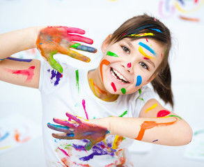 Cute girl playing with paints