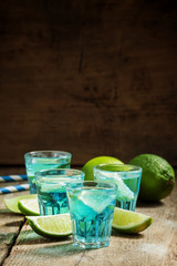 Blue cocktail with soda and lime, selective focus