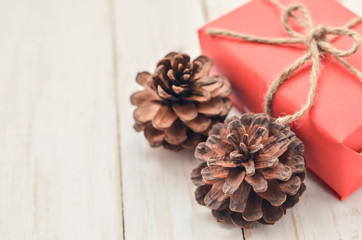 Close up of Pine cone and red box gift