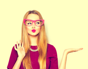Beauty girl with paper glasses on stick showing empty copy space on the open hand