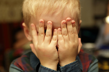 Boy playing hide and seek