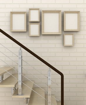 Empty picture frames in classic interior background with stairs on the decorative brick wall with wooden floor. Copy space image. 3d render