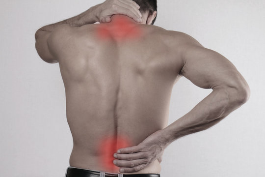 Close up of man rubbing his painful back. Pain relief concept