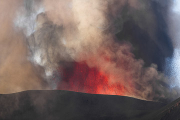 Volcano eruption. Mount Etna erupting from the crater Voragine
