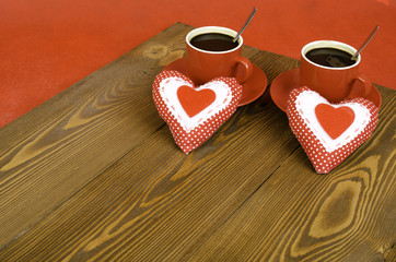 Two cups of coffee and two hearts.