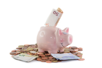 Porcellino rosa salvadanaio con monete e banconote 