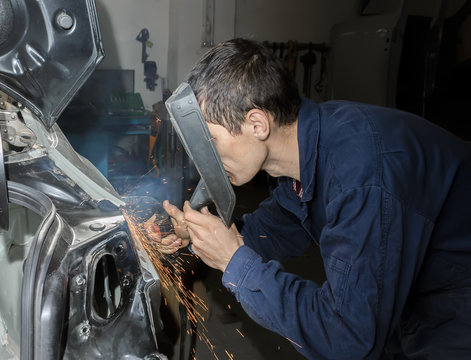 Man Welding A Car