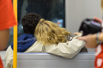 a romantic couple hug each other while looking through the glass