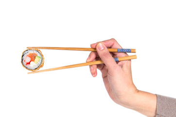 Woman hand holding fresh maki sushi roll with wooden chopsticks, © DD Images