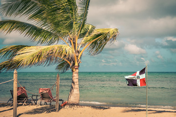 Fototapeta na wymiar Dominican Republic flag at the beach
