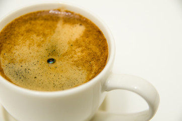 Cup of Coffee with Crema closeup isolated on White