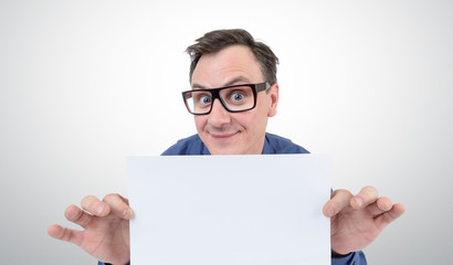 Happy businessman in glasses holding a white sheet of paper