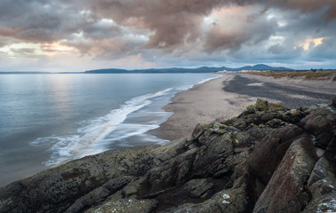Beautiful Cumulus Clouds over Rocky Coast in Wales
