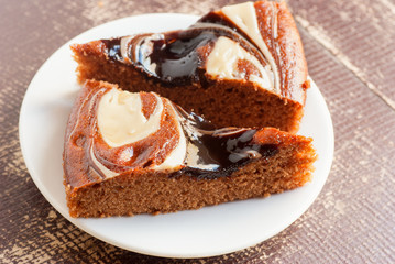 Pieces of chocolate cake cake on a white plate