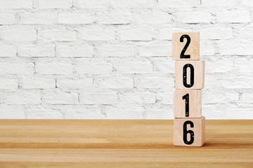 Wooden cubes with 2016 on table , new year background template