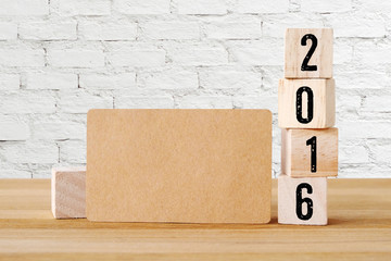 Blank card and wood cubes with 2016, new year background