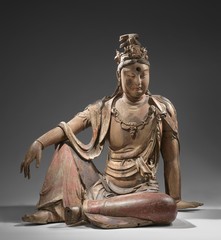 Buddhist deity Guanyin, saviour of people in peril, is represented meditating on a rock.