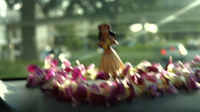 Hawaii Travel Car - Hula Doll Dancing On Dashboard And Lei During Road Trip