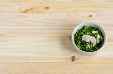 Stir Fried Pork with Chinese Chives Flower and Garlic on wooden