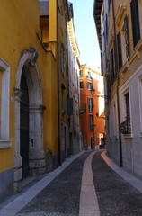 Fototapeta na wymiar Old and narrow street in Verona. Italy