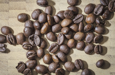 Many brown raw coffee beans close up