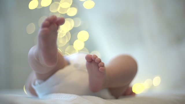 legs newborn on a background of bokeh lights
