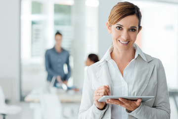 Professional business woman using a digital tablet